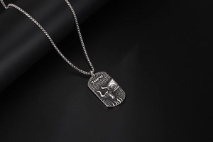 Close-up of vintage Taurus dog tag pendant with bull relief and metallic chain