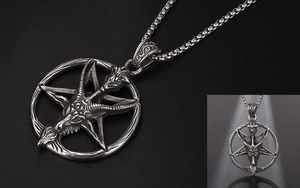 Macro shot of silver Baphomet goat head and pentagram pendant in gothic punk style
