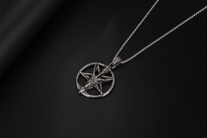 Close-up of gothic Baphomet goat head pendant with inverted pentagram on box chain