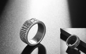 Macro shot of industrial wide titanium steel ring featuring rustic textured surface