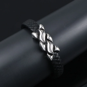 Men's braided black leather bracelet featuring a polished wavy metal centerpiece charm