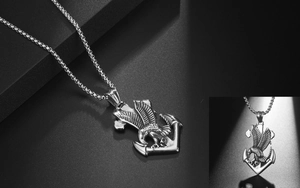 Detailed close-up of retro eagle and anchor pendant made of polished stainless steel