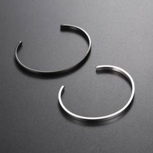 Minimalist C-shaped open bangles in brushed silver and matte black stainless steel