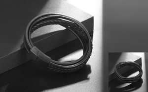 Close-up of black braided leather multi-layer bracelet with matte metal magnetic clasp