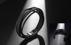 Detail of multi-layer black braided leather bracelet with matte black magnetic buckle
