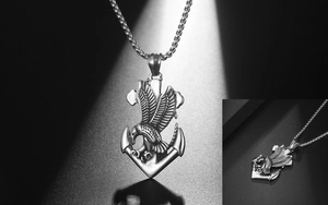 Detail of vintage eagle and anchor pendant on steel square box chain with dramatic lighting