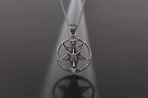 Macro detail of gothic Baphomet sheep skull pendant with vintage silver finish and bead chain