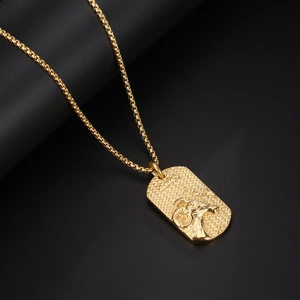 Polished gold Aries zodiac necklace with textured rectangular pendant and box chain