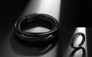 Macro detail of multi-layer braided black leather bracelet with matte metal magnetic clasp