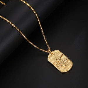 Polished gold Taurus zodiac pendant necklace with bull relief on black background