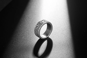 Macro detail of industrial vintage steel ring featuring embossed cracked texture and matte finish