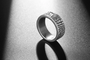 Macro shot of men's wide band ring featuring vintage distressed bark texture in antique silver