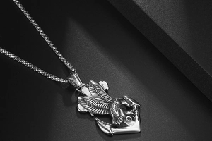 Macro detail of silver eagle and anchor pendant in stainless steel for men