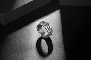 Detail of vintage grey titanium steel ring with handcrafted texture and matte finish