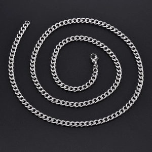 Macro shot of silver curb chain with polished flat links and secure lobster clasp