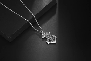 Close-up of polished silver eagle and anchor pendant on a premium woven chain necklace