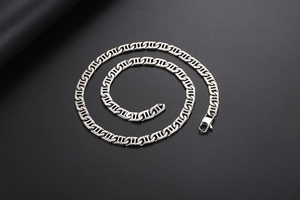 Detail of silver geometric H-link necklace with a secure lobster clasp on black background