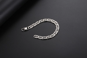 Detail view of industrial style silver link bracelet with a secure lobster clasp