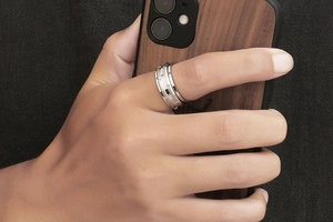 Close-up of men's titanium steel ring with geometric staggered rectangular design