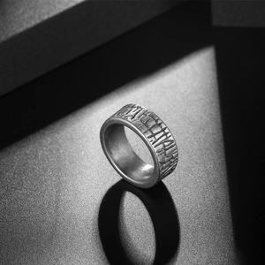 Textured titanium steel ring for men and women standing on a dark minimalist background