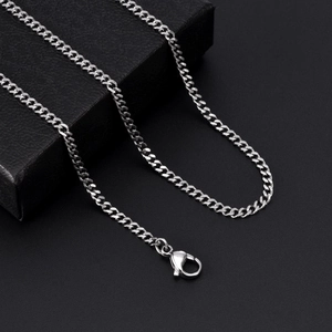 Close-up of polished silver titanium steel curb chain with classic lobster clasp closure