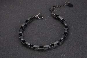 Macro detail of black titanium steel chain bracelet with lobster clasp and extender