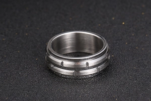 Macro shot of industrial titanium steel ring with brushed texture and vertical grooves