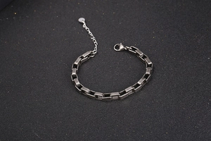 Detail of industrial rectangular link chain with lobster clasp and adjustable extension