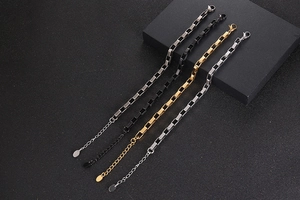 Close-up of four colors of geometric box chain bracelets with adjustable lobster clasps