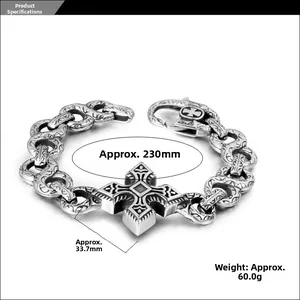 Detail of vintage punk bracelet with engraved cross and chunky steel links
