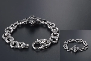 Close-up of vintage punk cross bracelet with gothic engravings and spring clasp