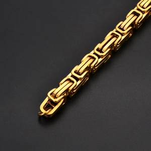 Macro shot of golden Byzantine chain links showing intricate stainless steel weave
