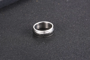 Detailed view of silver brushed titanium steel ring with engraved Nordic runic symbols