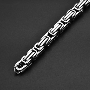 Close-up of polished silver Byzantine chain link texture and craftsmanship on bracelet