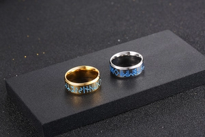 Dettaglio di anelli in acciaio al titanio con rune nordiche blu in oro e argento