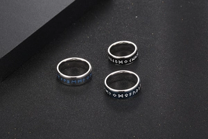 Detailed view of Viking style titanium steel rings with Nordic Runic engravings