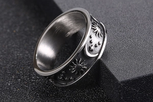 Detailed close-up of celestial sun moon and star motifs on vintage stainless steel ring