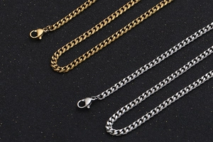 Detail view of gold and silver cuban link chains with classic lobster clasp closure