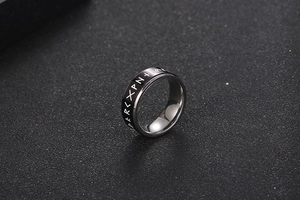 Macro view of Nordic runic titanium ring with rotatable black enamel center band