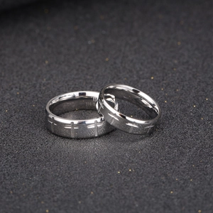 Polished silver 316L stainless steel couple rings with engraved cross patterns