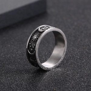 Polished stainless steel ring with celestial sun moon and star engravings in black and silver