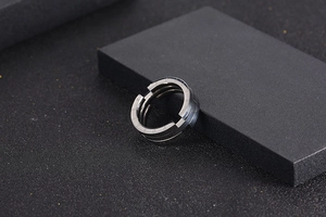 Detail of matte titanium steel ring with Forever engraving on a dark industrial base