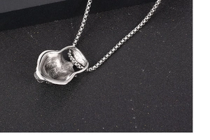 Macro shot showing the back and side thickness of the vintage skull wolf pendant