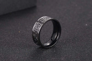 Detailed close-up of a black Viking Celtic knot ring with textured relief pattern