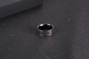Macro detail of Nordic Viking black ring featuring raised Celtic knot relief pattern