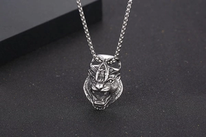 Detail view of the wolf head pendant with skull crown in vintage titanium steel