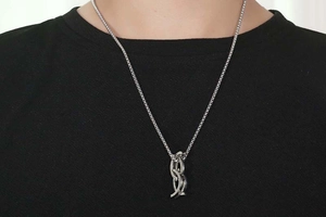 Silver titanium steel necklace with interlocking irregular rings on black shirt