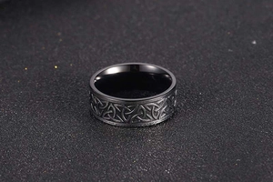 Detail of vintage Viking black steel ring showing Celtic knot engravings and matte finish