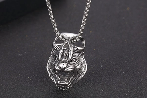 Macro shot of tiger head pendant with skull bail and vintage finish steel box chain