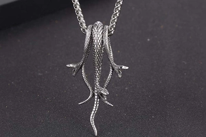 Macro detail of gothic titanium steel mamba snake pendant with intricate scale texture